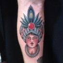 traditional gypsy head woman on forearm with big hat and jewel with feathers